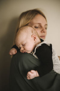 Mother holding sleeping newborn baby