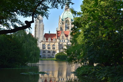 Canal amidst buildings against sky