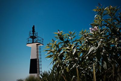 Low angle view of lighthouse against clear blue sky