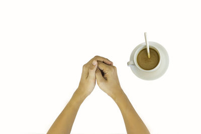 Woman holding coffee cup against white background