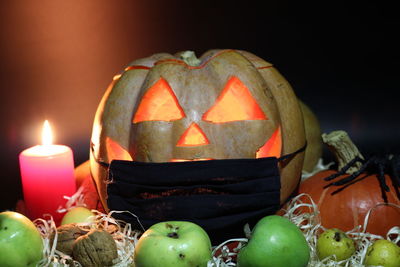 Close-up of illuminated pumpkin against black background