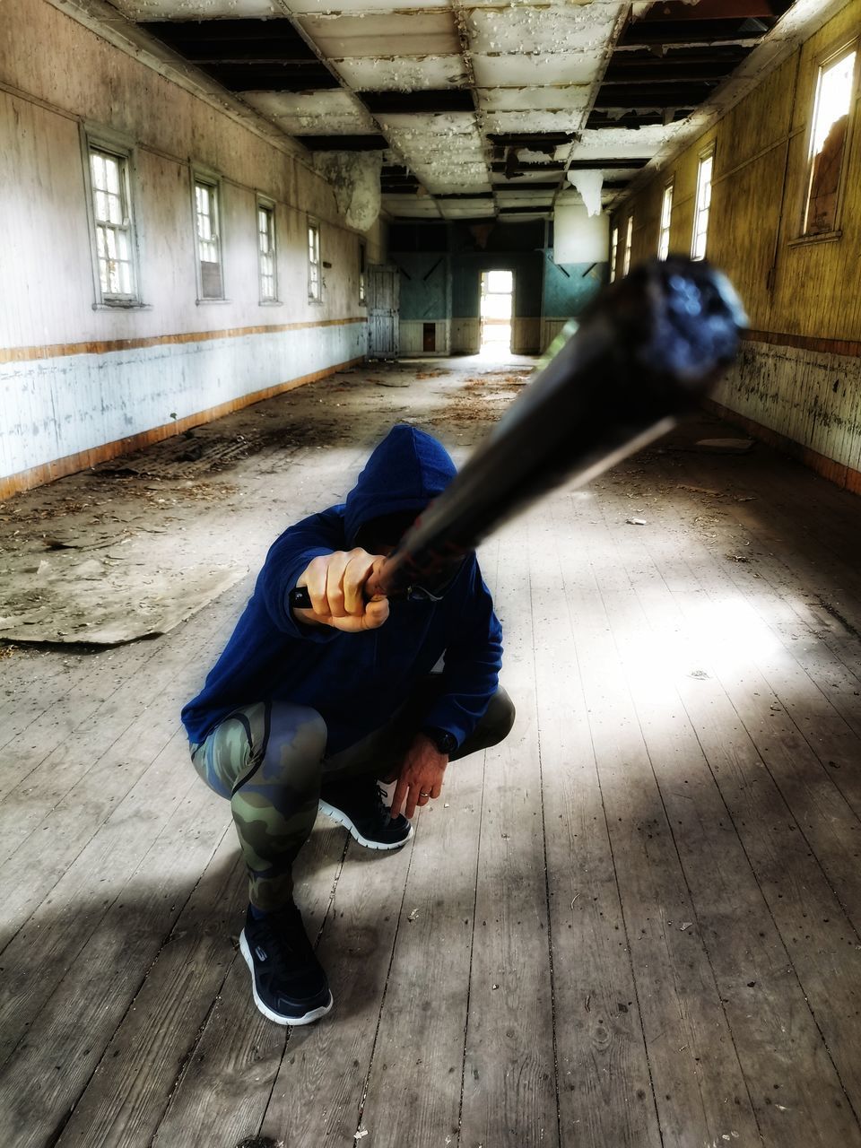 SIDE VIEW OF MAN WALKING ON WOODEN FLOOR IN BUILDING