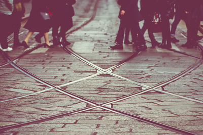 Low section of people walking on street