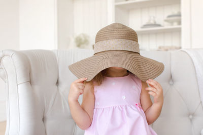 Midsection of woman wearing hat