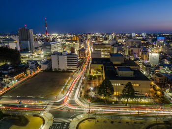 High angle view of illuminated buildings in city at night