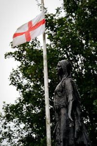 Low angle view of statue against trees