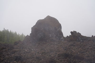 Rock formations on landscape against clear sky