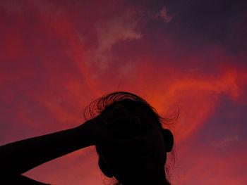 Silhouette of man against sky at sunset