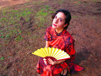 Portrait of man holding camera on field