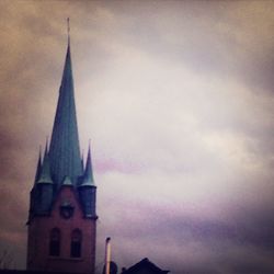 Low angle view of church against cloudy sky