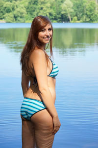 Portrait of sensuous bikini woman by lake