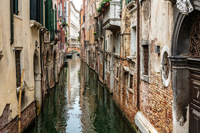 Canal amidst buildings in city