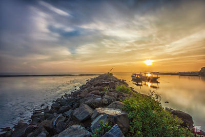 Scenic view of sea against cloudy sky