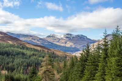 Scenic view of mountains against cloudy sky