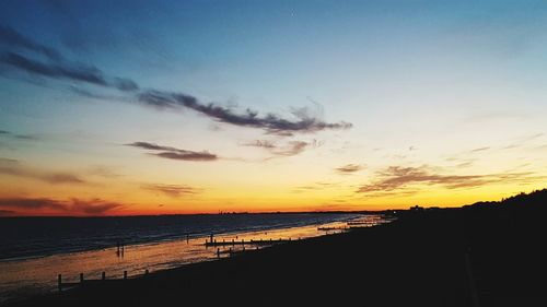 Scenic view of beach against sky during sunset