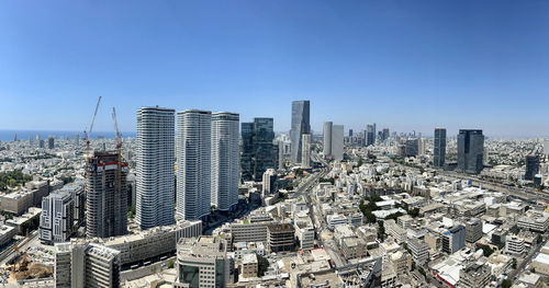 Cityscape against clear blue sky