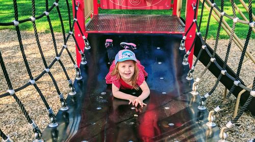 Portrait of smiling girl at jungle gym