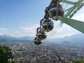 Ferris wheel in city against sky