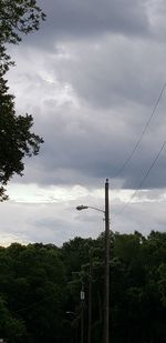 Low angle view of electricity pylon against sky