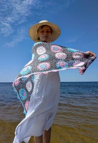 Full length of child standing on beach against sky