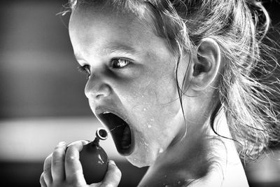 Close-up of girl drinking water from balloon