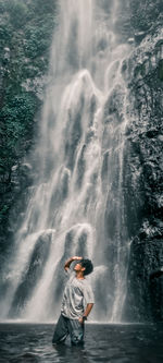 Full length of man splashing water in sea