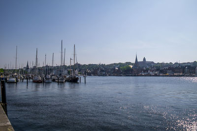 Sailboats in sea against sky