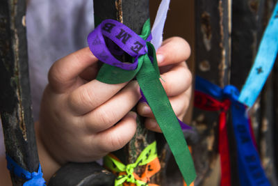 Close-up of hand holding multi colored leaf