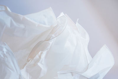 Close-up of crumpled paper against wall