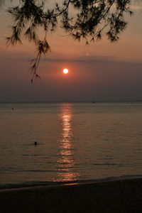 Scenic view of sea against orange sky