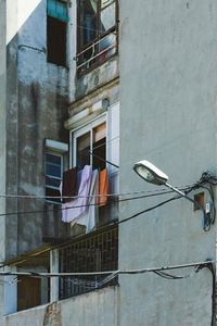 Low angle view of clothes drying against window