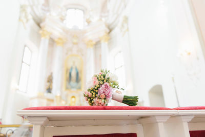 Beautiful bridal bouquet of the bride lies in the temple