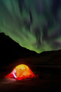 Tent on mountain against sky at night