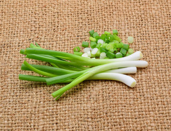 High angle view of fresh scallions on burlap