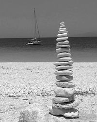 Sailboat on beach against sky