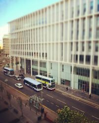 Tilt-shift image of cars on road in city