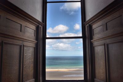 Close-up of sea against sky seen through window