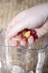 Close-up of hand holding ice cream in glass