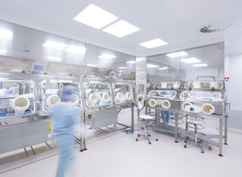 Scientists processing human tissue in insulator laboratory