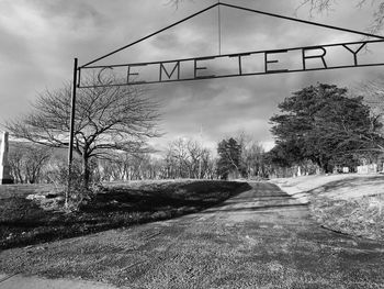 Empty road against cloudy sky