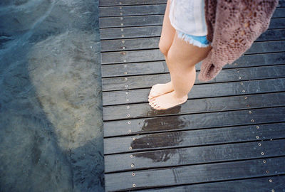 Low section of woman standing on tiled floor