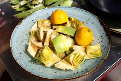 High angle view of fruits in plate on table