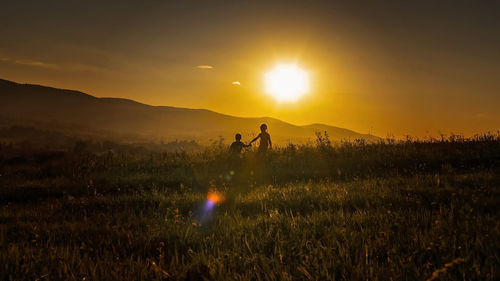 Scenic view of field against sky during sunset