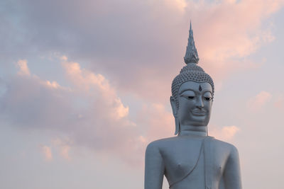 Statue of buddha against building