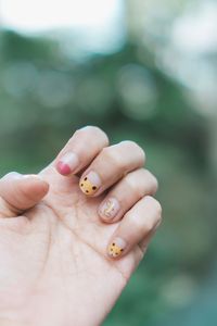 Close-up of hand holding small finger