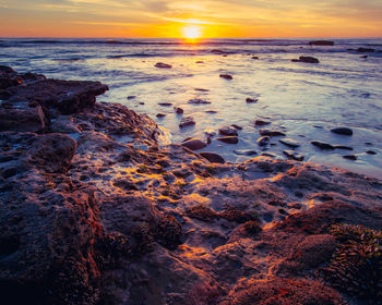 Scenic view of sea against sky during sunset