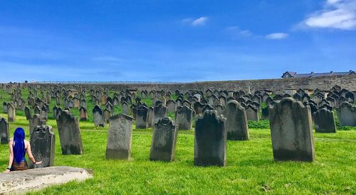 Panoramic view of cemetery on field against sky
