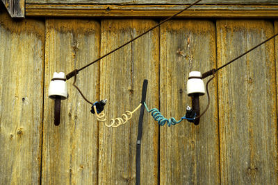 Close-up of electric lamp hanging on wall