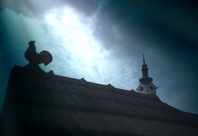 Low angle view of building against cloudy sky