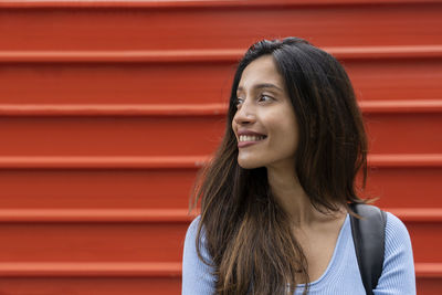 Portrait of smiling young woman looking away